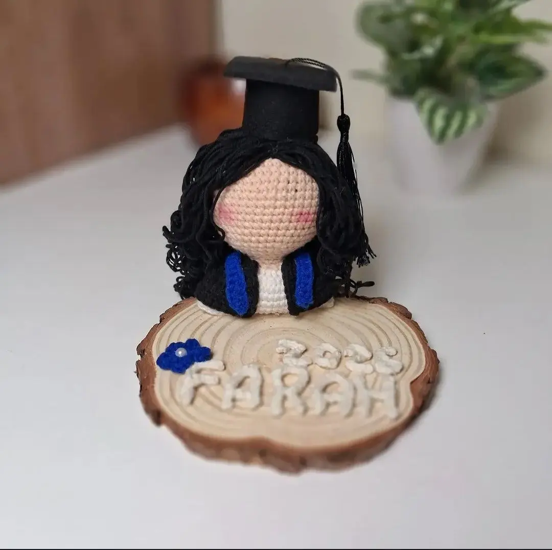 Graduation doll on wood base